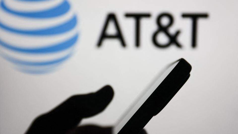 AT&T logo with person holding smartphone